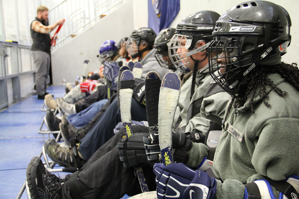 A team prepares for sled hockey